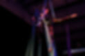Two white female bodied students perform on aerial silks. Each are wrapped in such a way that their left leg extends out behind them in an adagio.