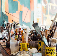 People enjoying a paint and sip, wearing aprons