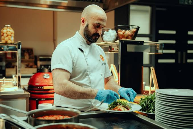 Omar assembling a meal during his time at Manchester United (Photo credit to Manchester United)