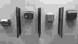 Various hand dryers on a bathroom wall