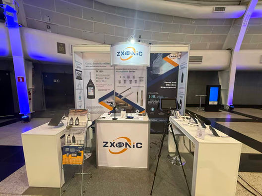 Visitors exploring ZXONIC acoustic and vibration measurement instruments at Inter-Noise 2025 Brazil.