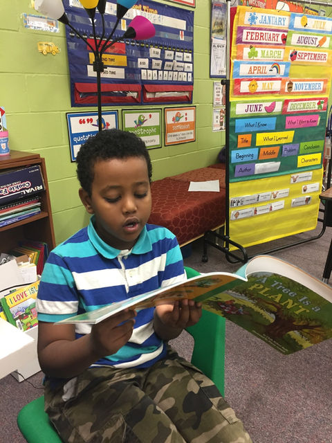 young student reading book
