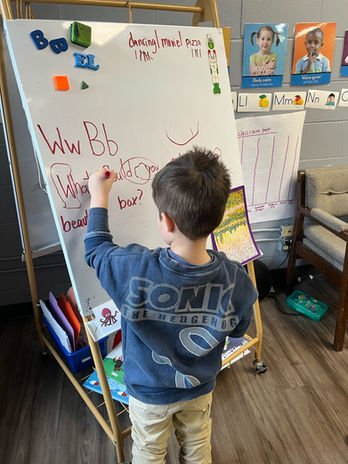student writing on white board