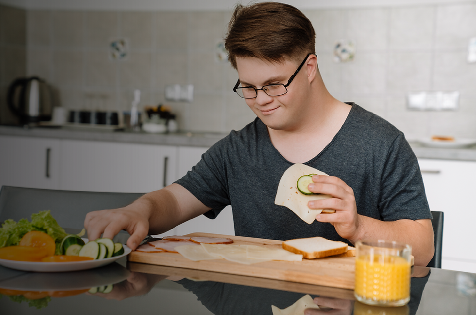 young man with Down syndrome making a sandwich