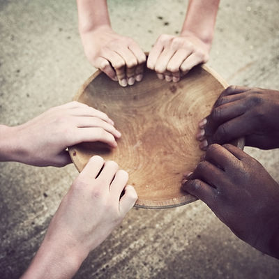 Hands Holding Wooden Plate