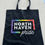 Thumbnail: Black tote with North Haven Pride logo on it being held by a person