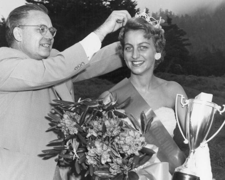 Lolita Buchanan of Spruce Pine is crowned the 1958 North Carolina Rhododendron Queen by John Jones of the Asheville Citizen Times.- Mitchell County Historical Society