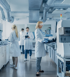 Team of Research Scientists Working On Computer, with Medical Equipment, Analyzing Blood a