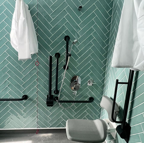 Bathroom with green herringbone tiles