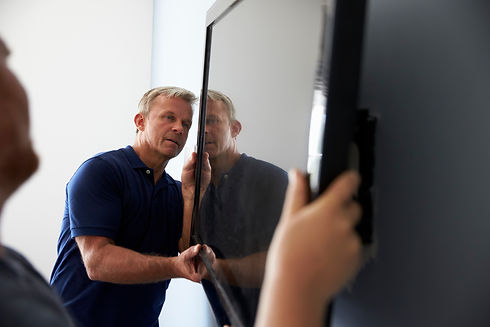 two-men-fitting-flat-screen-television-to-wall-2024-10-21-23-30-09-utc.jpg