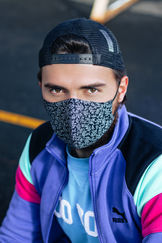 headshot of a man wearing a mask