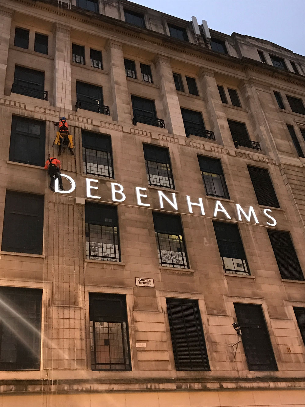Industrial access specialist working on Debenhams sign