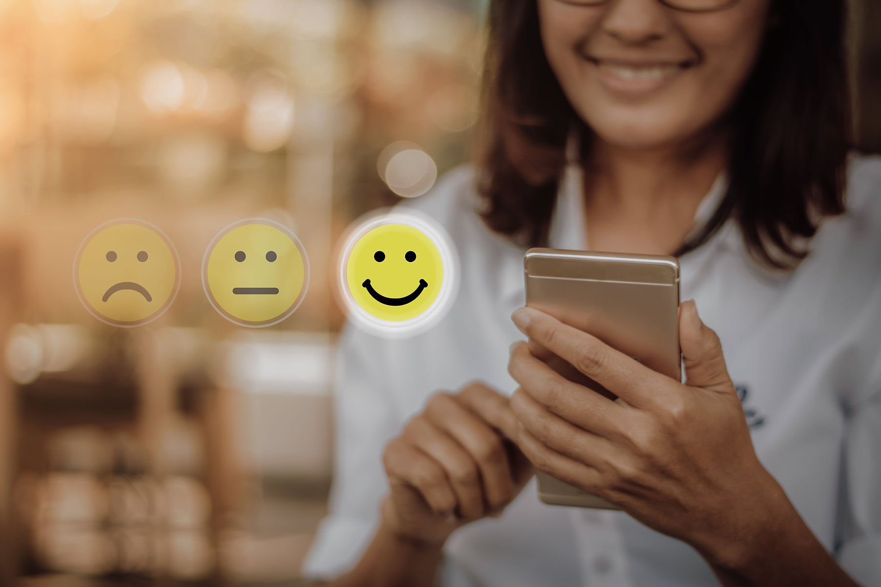 Businesswoman pressing face emoticon on virtual touch screen at smartphone .Customer servi