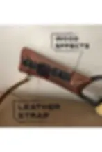 Thumbnail: Close-up of the weathered wood FX on the grip with attached leather strap, labeled “Leather Strap” and “Wood Effects