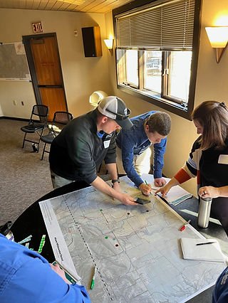 People identifying features on a topographic map
