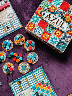 A faded image of the board game Azul set up on shot from the top.