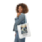 Thumbnail: Woman holding Christian Tote Bag with "The Great Wave" design