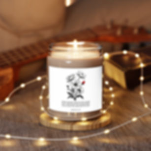 Lit candle with floral label, fairy lights