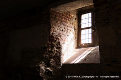 Light falling into a dark cellar through a small window of hope