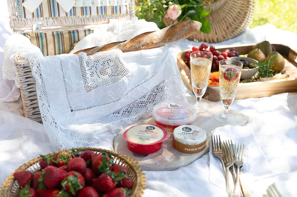 Platters of food and drink set out for an outdoor picnic