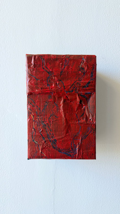 Red and dark blue acrylic painting on recycled cardboard box in the technique of graffiato.