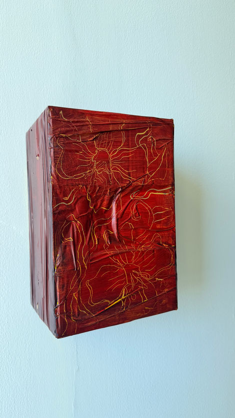 Red and dark blue acrylic painting on recycled cardboard box in the technique of graffiato.