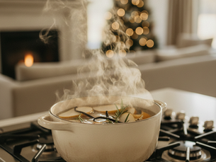 cooking dinner on the stove with christmas tree in the background