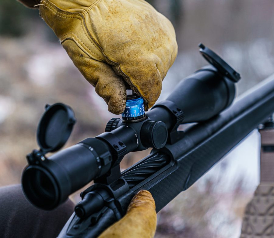 Huskemaw Blue Diamond scope in the field being adjusted using the top turret.