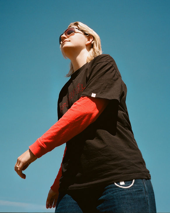 Analog portrait of DJ benny 2, blue sky, film photography by Susan Eline Amsterdam