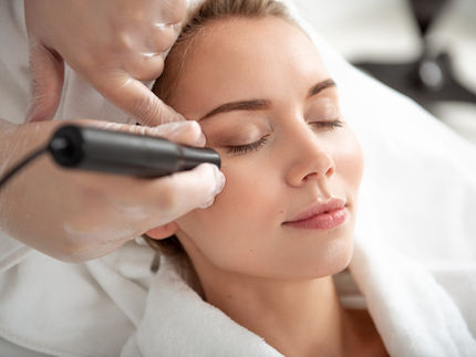 Woman receiving professional dermatological treatment at a medical clinic for rolling scar improvement