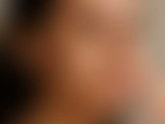 Woman applying skincare cream to her cheeks as part of a consistent skincare routine for skin health.