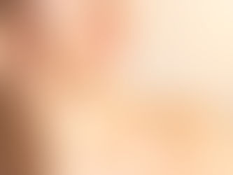 Close-up of a smiling woman applying niacinamide cream to her cheeks, focusing on the lower half of the face.