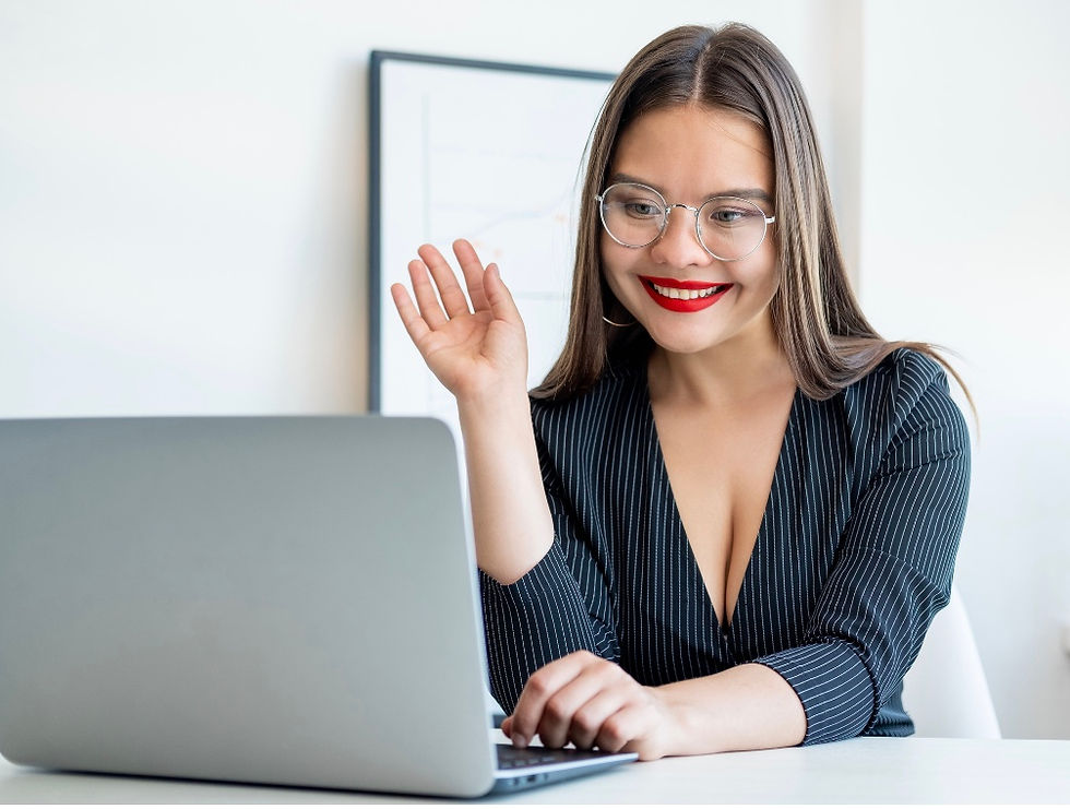 Woman waving to a zoom meeting