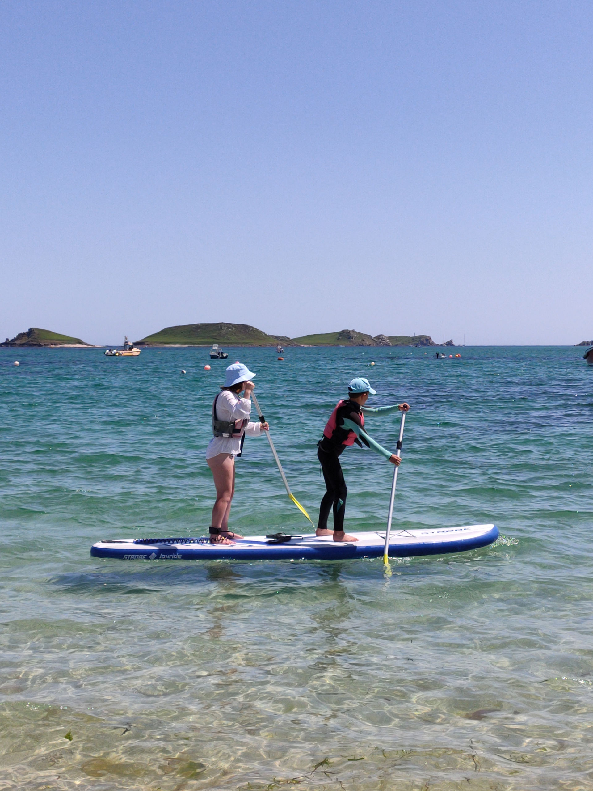 Two people on a paddle board of St Martins Scilly
