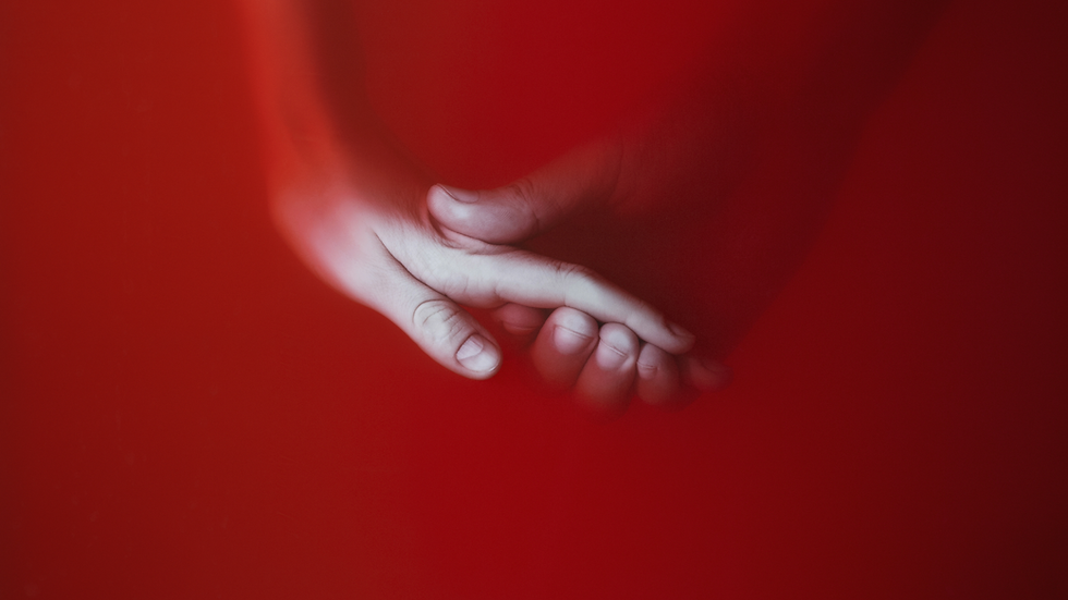 A symbolic image of two hands gently holding, representing love, connection, and biblical relationship wisdom.