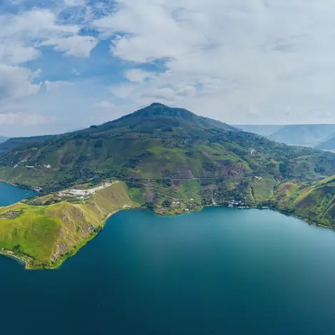 Aerial view of Lake Toba and Samosir Island surrounded by green hills in North Sumatra, Indonesia
