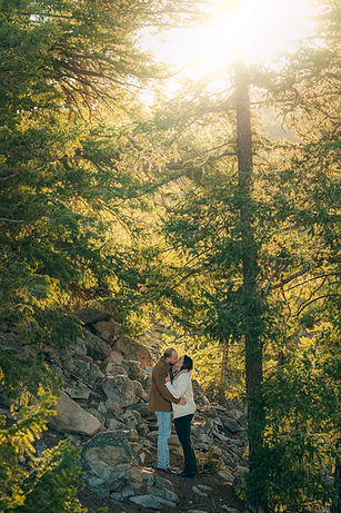 Dreamy Engagement photos at Saphire Point in green trees, couple kissing with morning light