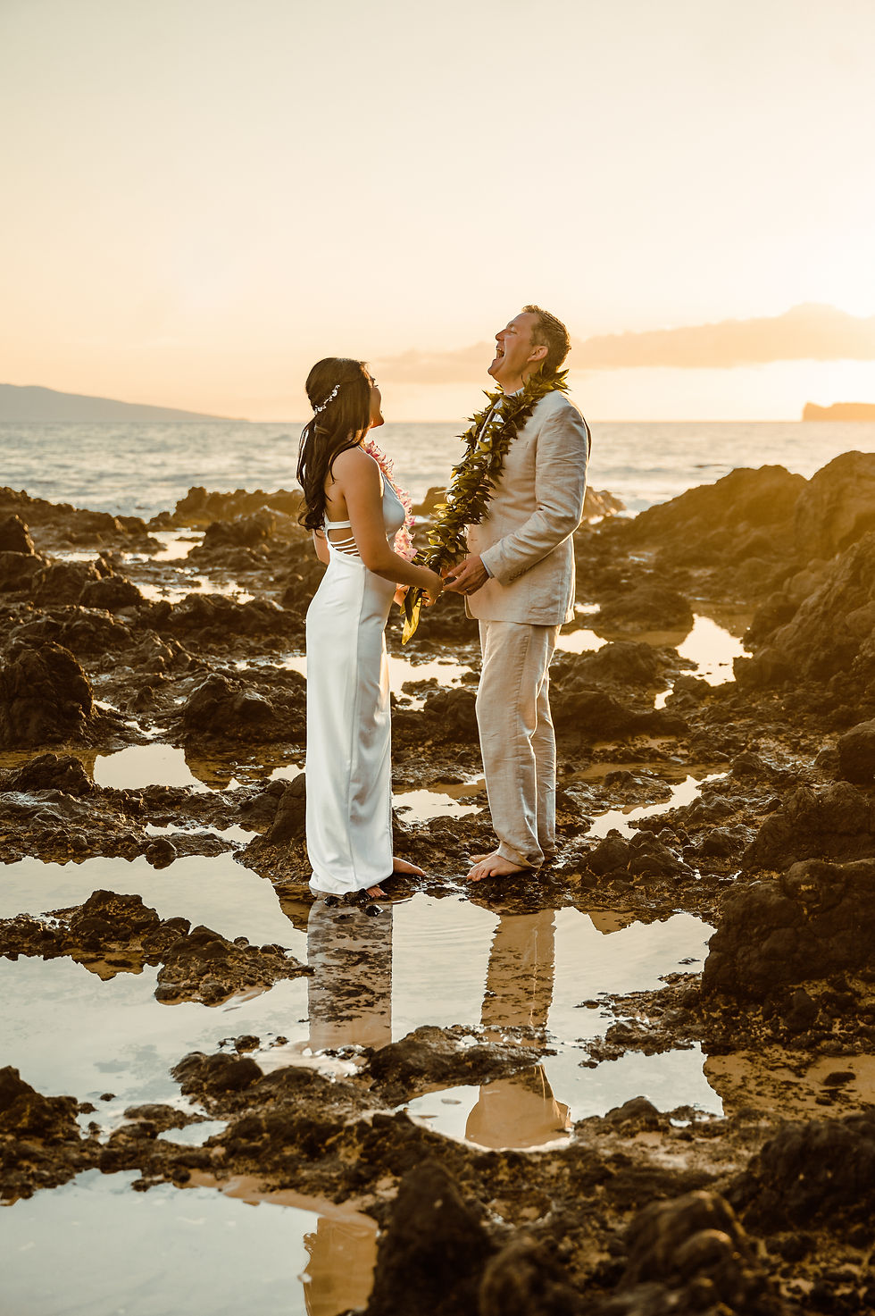 Maui wedding on the beach at sunset. Couple laughing