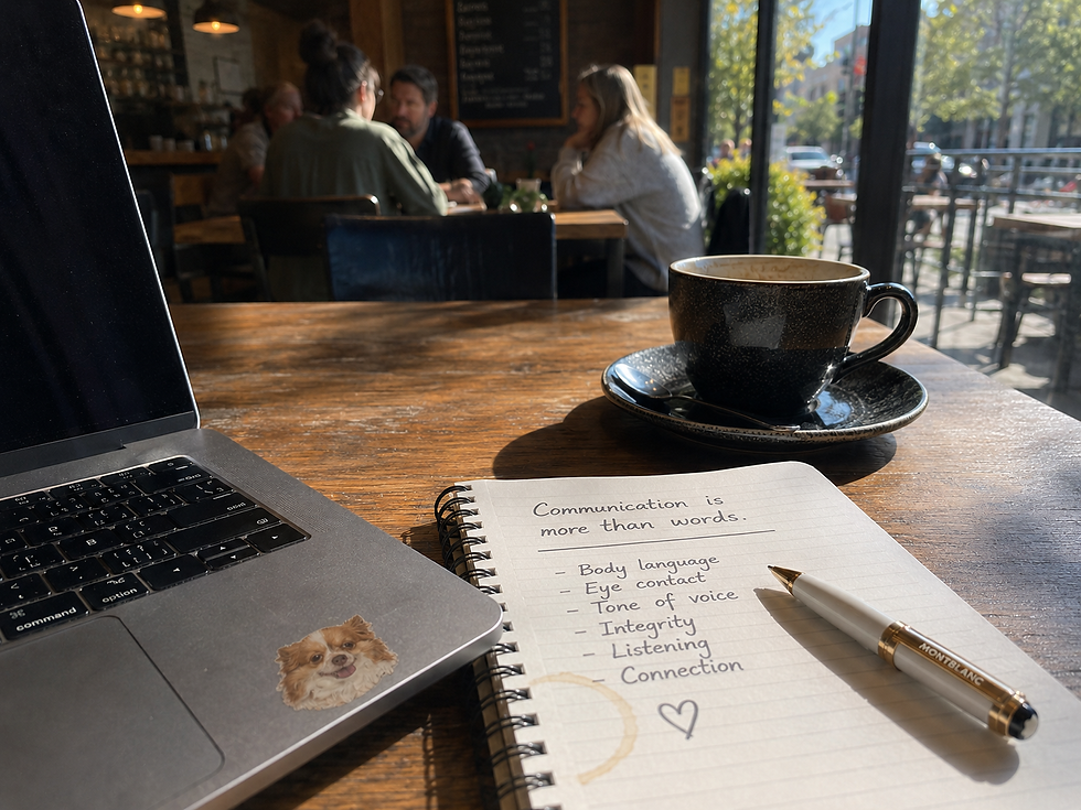 Laptop, notebook and coffee in a café representing how communication is more than words