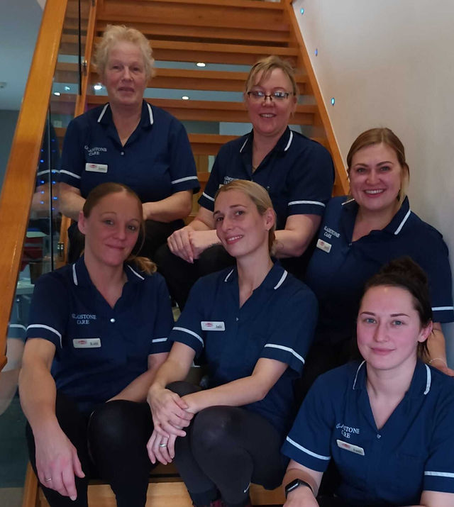 Gladstone Care staff sitting on step