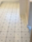 White floor tiles with a classic black and white geometric pattern in a bright room