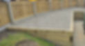 timber sleepers and raised stone surface next to new fencing