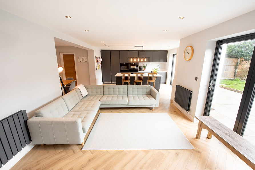 inside a house extension with sofa and kitchen area