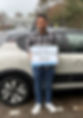 man beside car with a pass card