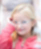 young girl trying on clear-framed glasses