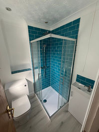 corner shower cubicle with turquoise tiles
