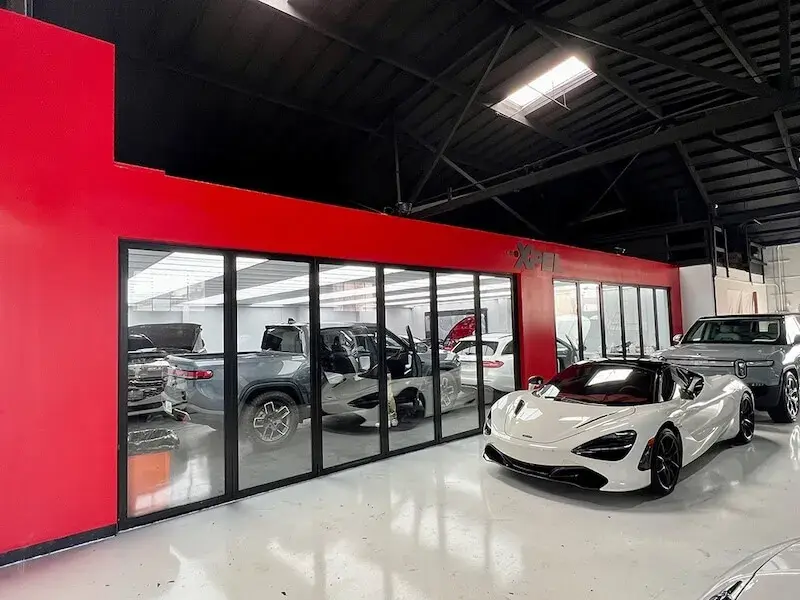 Modern commercial exterior and interior featuring large-scale glass folding doors and curtain walls by EZ FOLD A DOOR, showcasing professional architectural glazing for business environments.