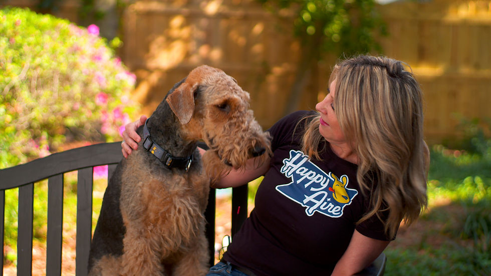 Kim Opdyke, founder of Happy Aire, shares a quiet moment with her Airedale Terrier — the kind of connection that inspired her canine cancer awareness community.