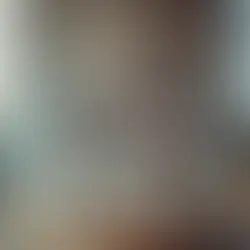 Dimly lit room with a table covered in lit candles, an open book, and mystical items. Smoke drifts around, creating a mysterious aura.