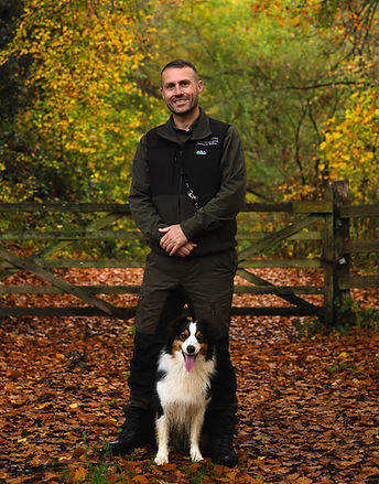 Stephen Gardner from SG Canine Adventures and his australlian sheppard sitting well behaved between his legs in wincanton